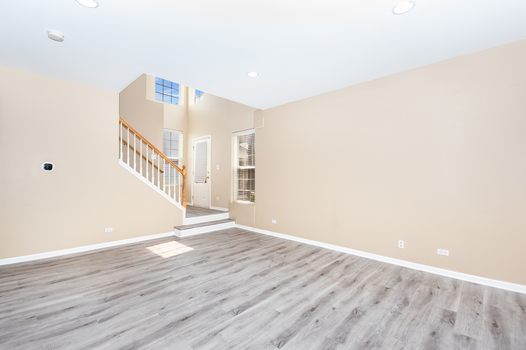 3160 Bromley Lane Aurora, IL 60502 - Photo 2 of 15 a view of an empty room with wooden floor