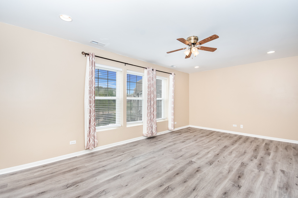 3160 Bromley Lane Aurora, IL 60502 - Photo 7 of 15 an empty room with wooden floor and windows