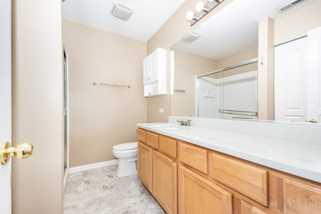 3160 Bromley Lane Aurora, IL 60502 - Photo 8 of 15 a bathroom with a granite countertop sink mirror vanity and toilet