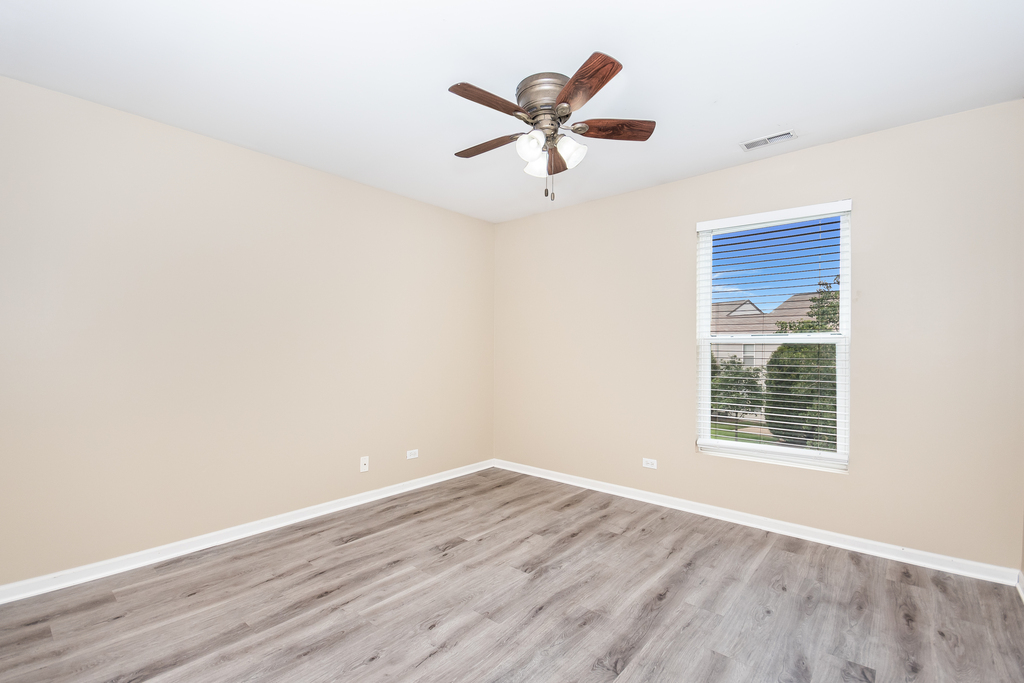 3160 Bromley Lane Aurora, IL 60502 - Photo 9 of 15 a view of a big room with wooden floor a ceiling fan and wooden floor