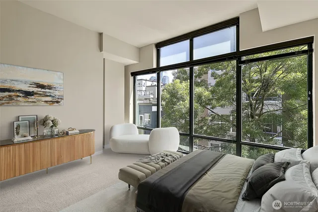 a bedroom with furniture and a large window