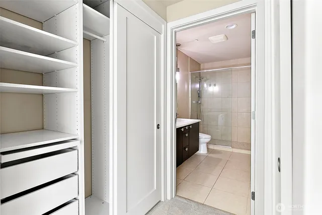 a view of a hallway with closet and a living room