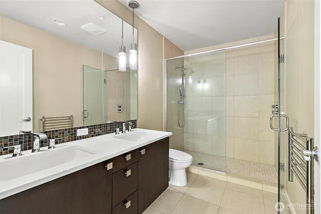 a bathroom with a double vanity sink mirror double shower and a bathtub