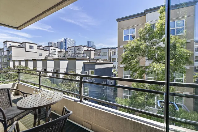 a view of a chairs and table in the balcony