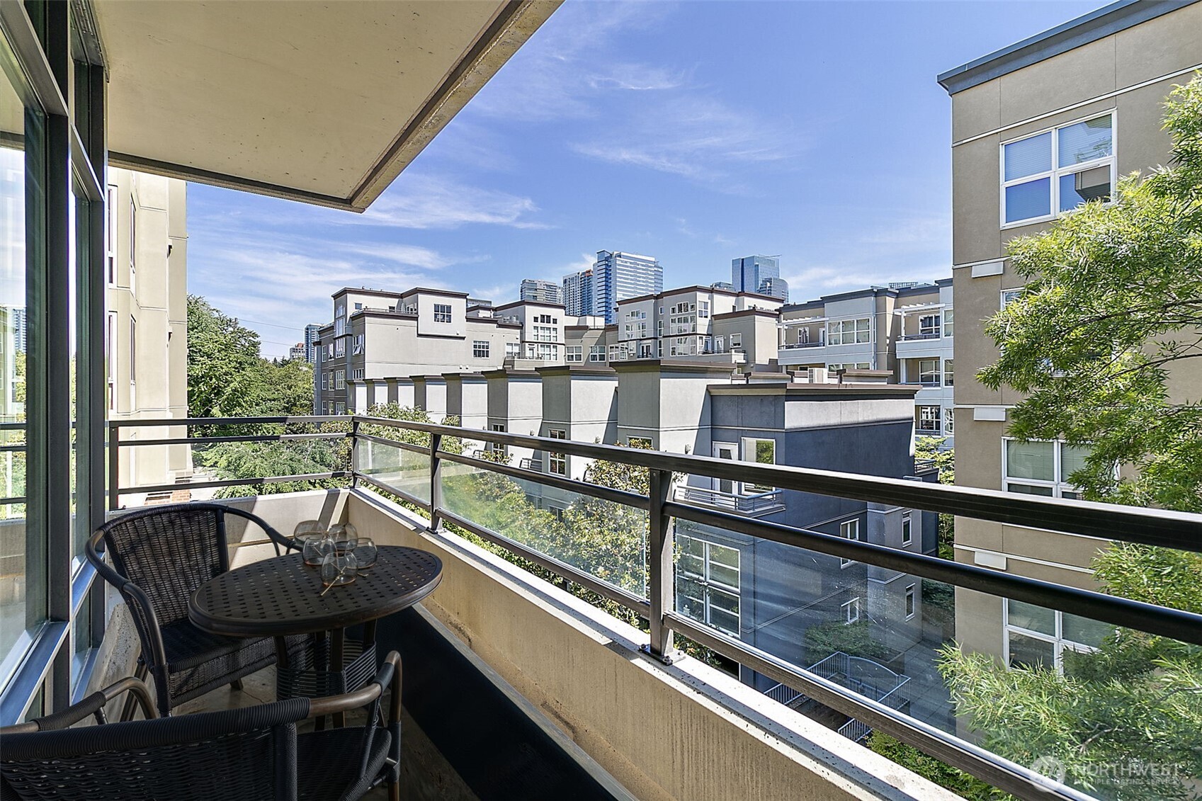 10000 Main Street, Unit 504 Bellevue, WA 98004 - Photo 19 of 37 a view of a chairs and table in the balcony