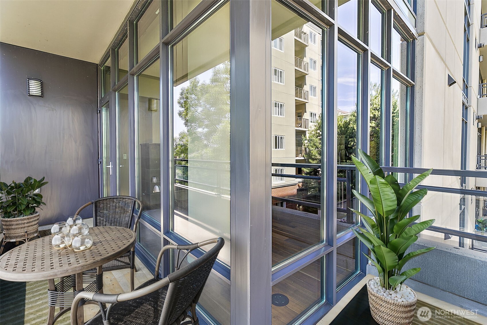 10000 Main Street, Unit 504 Bellevue, WA 98004 - Photo 20 of 37 a dining room with furniture potted plants and wooden floor