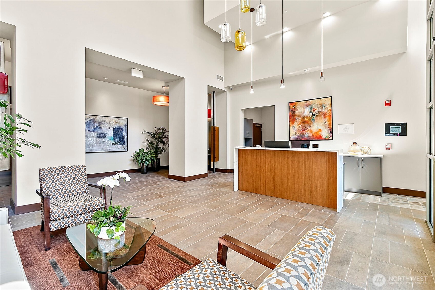 10000 Main Street, Unit 504 Bellevue, WA 98004 - Photo 23 of 37 a living room with kitchen island furniture and a chandelier