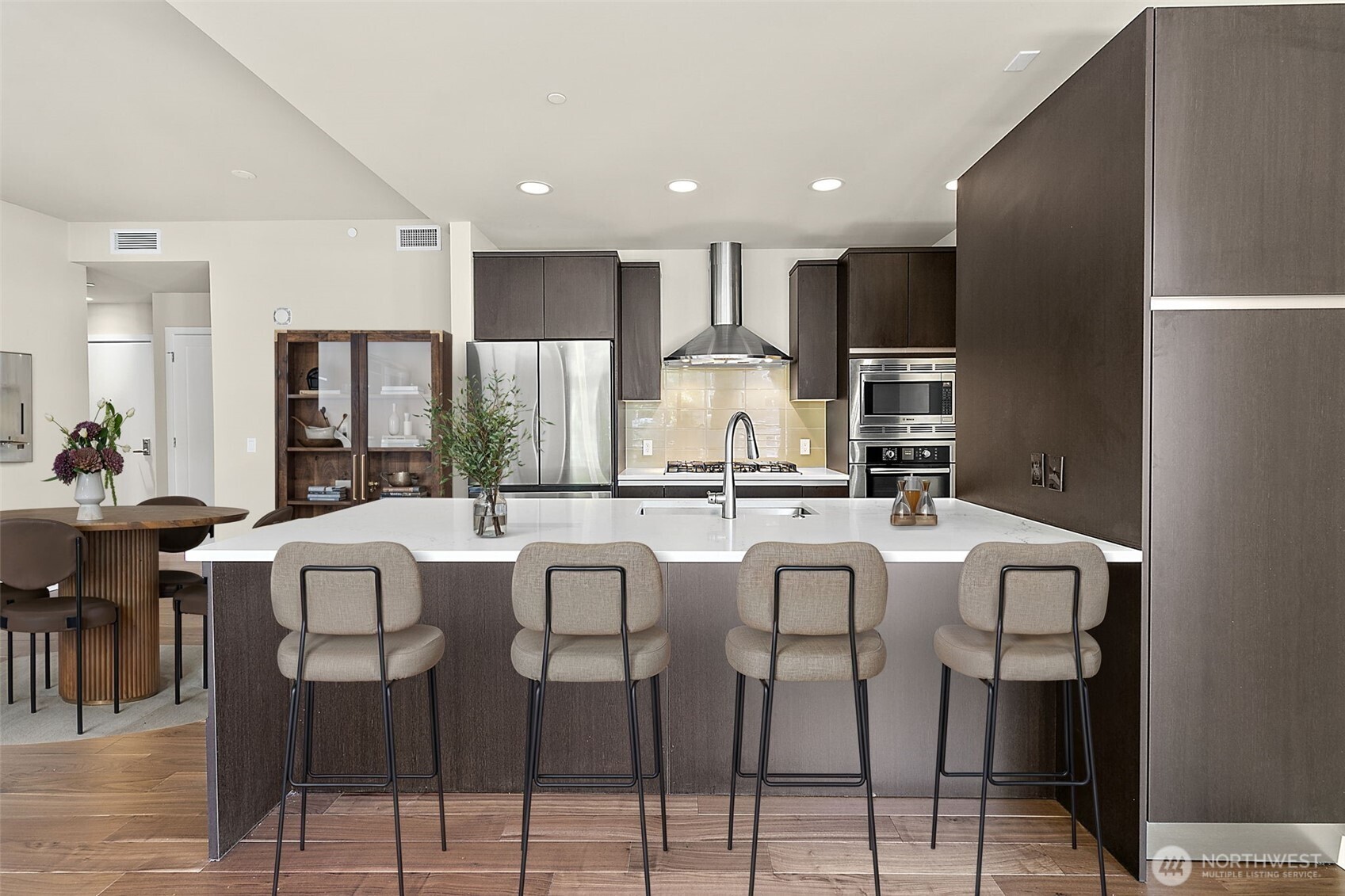10000 Main Street, Unit 504 Bellevue, WA 98004 - Photo 3 of 37 a large kitchen with a table and chairs