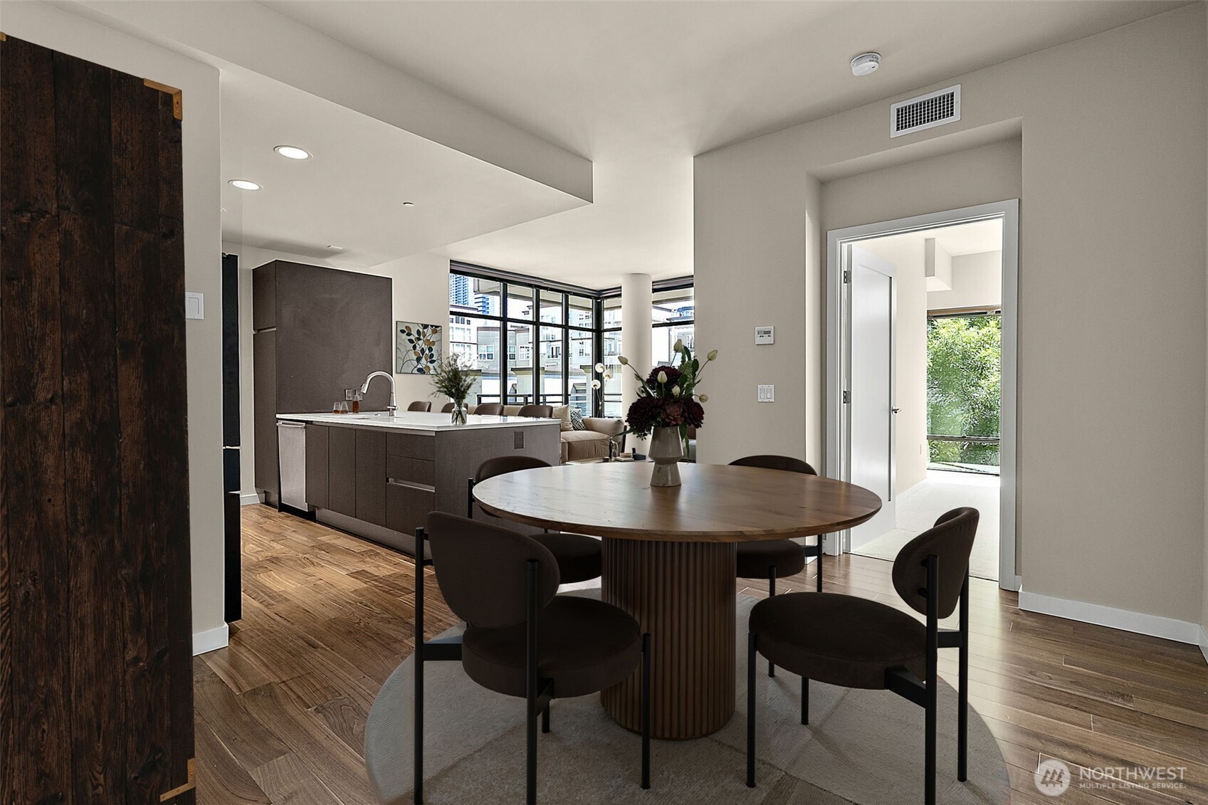 10000 Main Street, Unit 504 Bellevue, WA 98004 - Photo 5 of 37 a view of a dining room with furniture and wooden floor