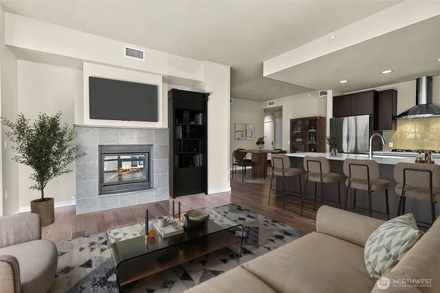 a living room with furniture fireplace and flat screen tv