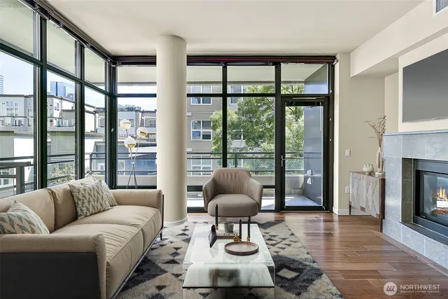a living room with furniture and floor to ceiling windows