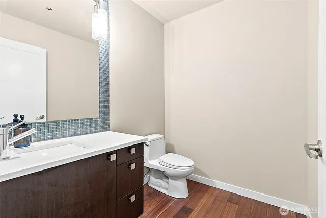 a bathroom with a sink a toilet and a mirror