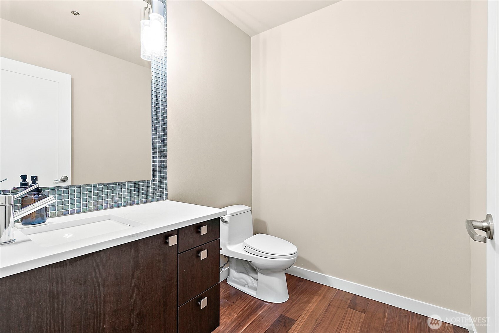 10000 Main Street, Unit 504 Bellevue, WA 98004 - Photo 10 of 37 a bathroom with a sink a toilet and a mirror