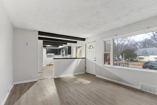 a kitchen with kitchen island a sink appliances and cabinets