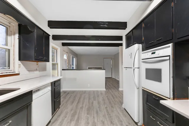 an empty room with closet and a chandelier fan