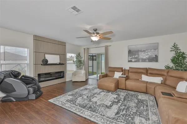 a living room with furniture ceiling fan and a rug