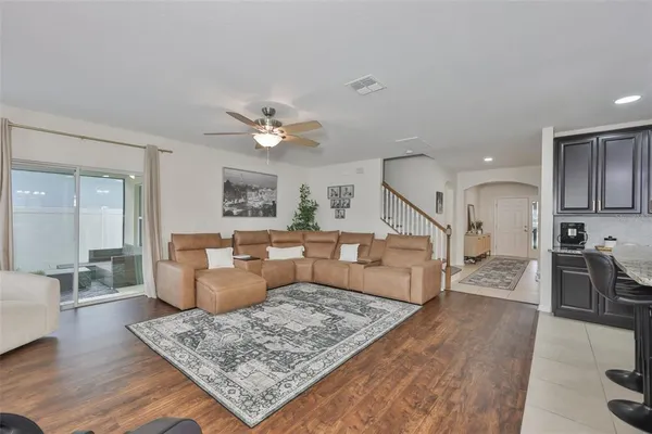 a living room with furniture and wooden floor