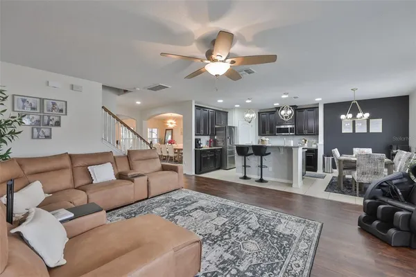 a living room with furniture and wooden floor