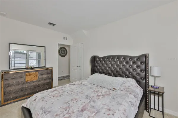 a bedroom with a bed and a dresser