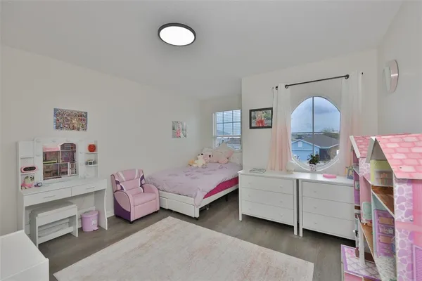 a bedroom with a bed and a baby bed