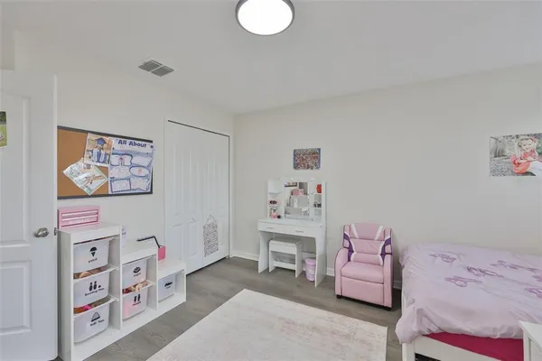 a bedroom with a bed and a book shelf