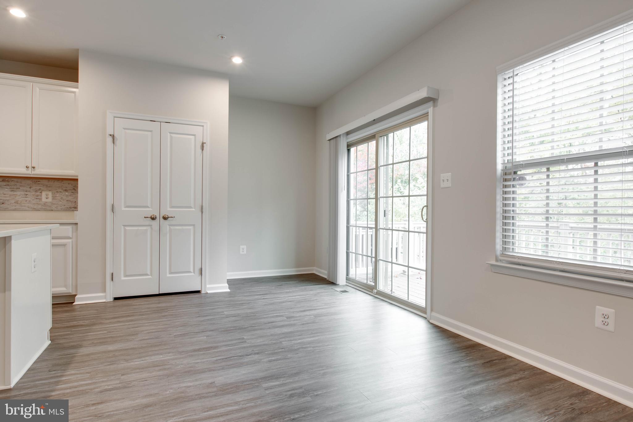 3004 Cornfield Avenue Hanover, MD 21076 - Photo 14 of 50 an empty room with wooden floor and windows