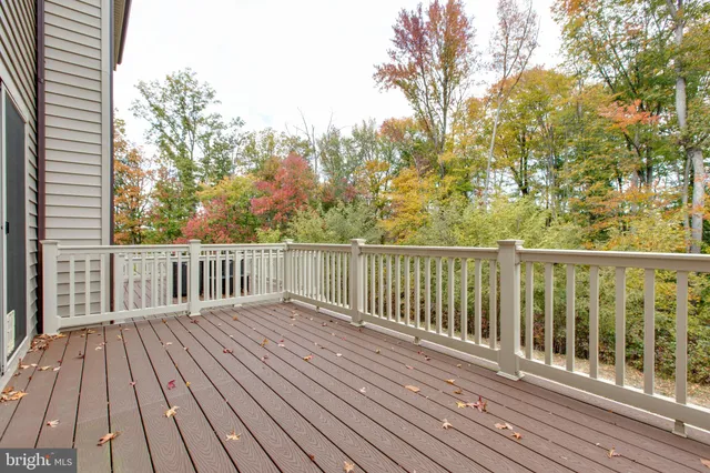 a view of balcony with wooden floor and fence