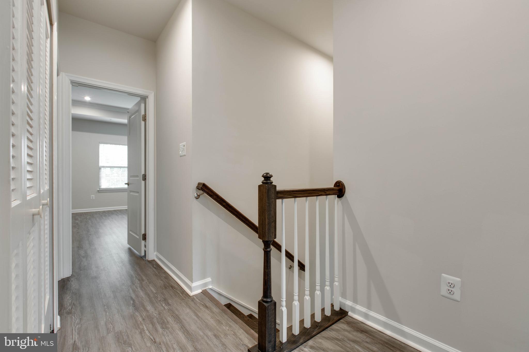 3004 Cornfield Avenue Hanover, MD 21076 - Photo 37 of 50 a view of a hallway with wooden floor and staircase