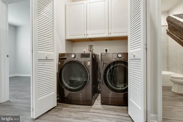 a utility room with sink dryer and washer