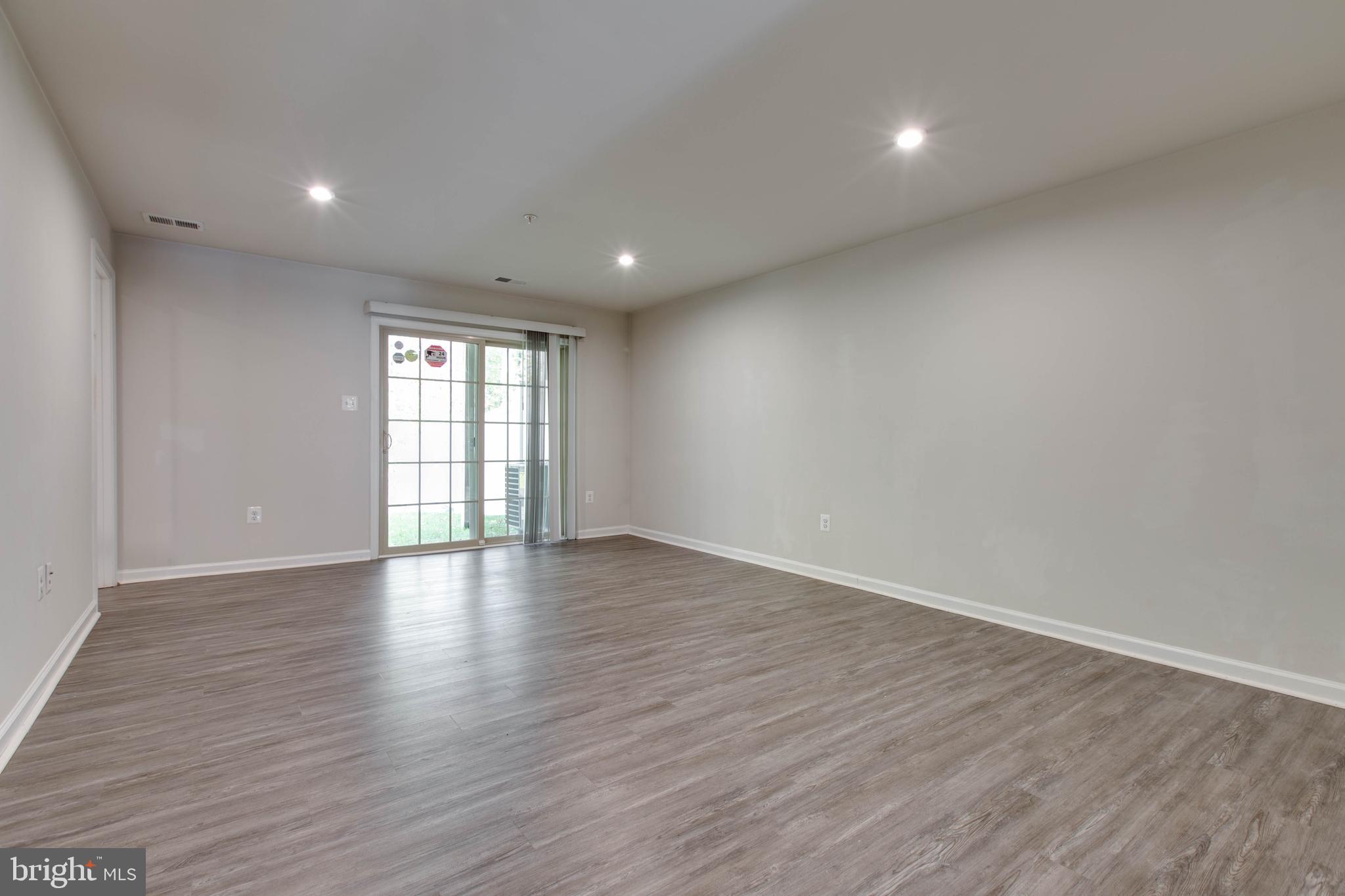 3004 Cornfield Avenue Hanover, MD 21076 - Photo 39 of 50 a view of an empty room with wooden floor and a window