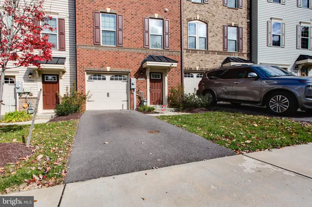 a car parked in front of a brick house