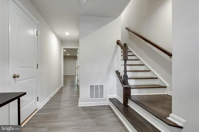 a view of entryway and hall with wooden floor