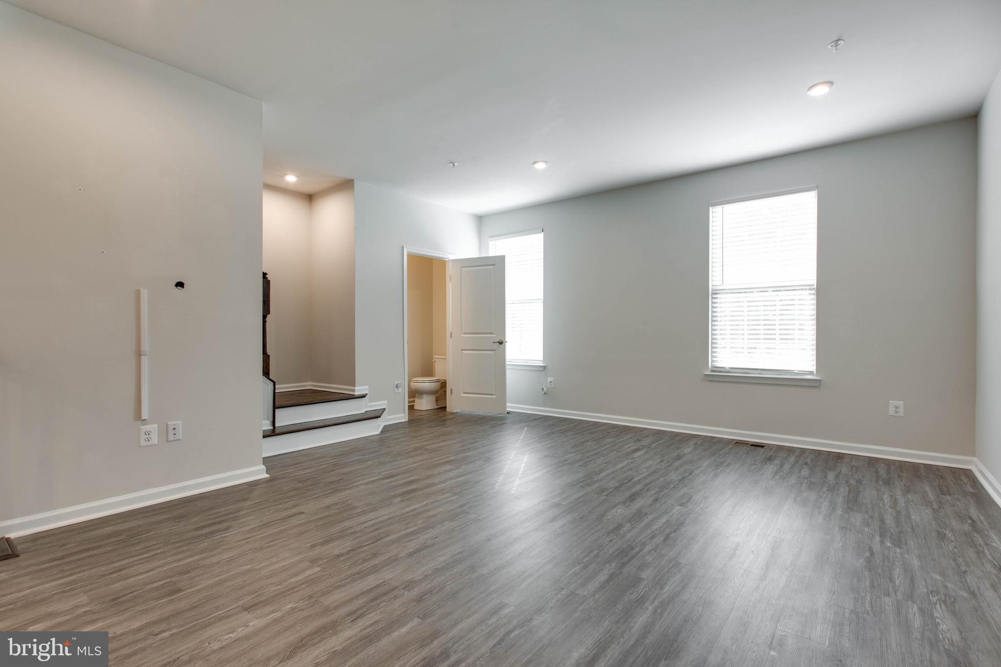 3004 Cornfield Avenue Hanover, MD 21076 - Photo 8 of 50 an empty room with wooden floor and windows