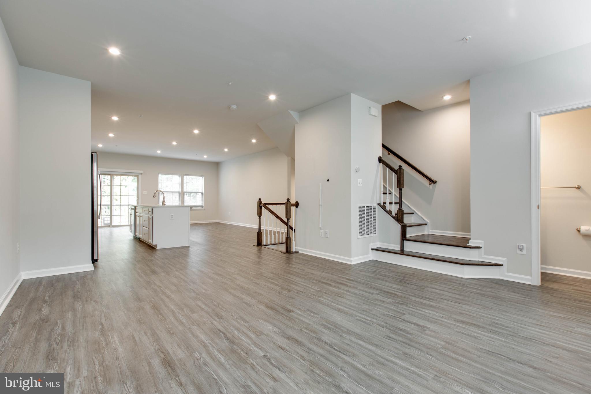 3004 Cornfield Avenue Hanover, MD 21076 - Photo 9 of 50 a view of an empty room with wooden floor and a window
