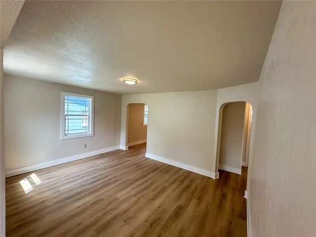 an empty room with wooden floor and closet