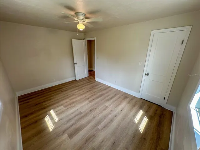 wooden floor in an empty room with a window