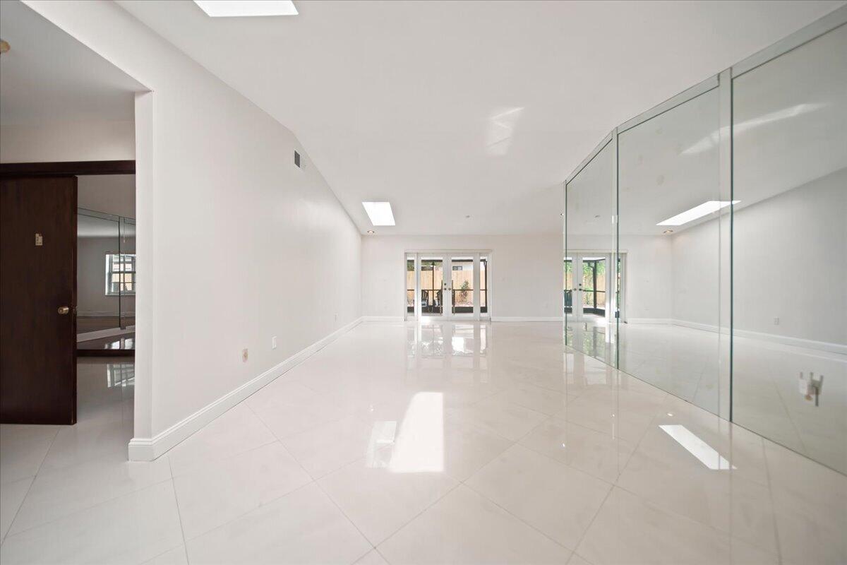 20009 Northwest 66th Place Hialeah, FL 33015 - Photo 6 of 33 a view of a hallway with wooden floor and a bathroom
