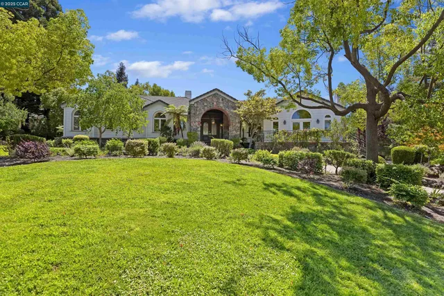 a front view of house with yard and green space