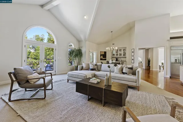 a living room with furniture a fireplace and a large window