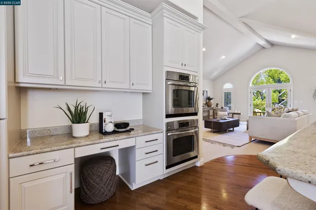 a kitchen with sink cabinets and wooden floor
