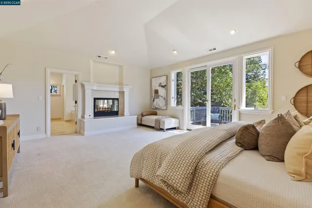 a bedroom with bed and a large window