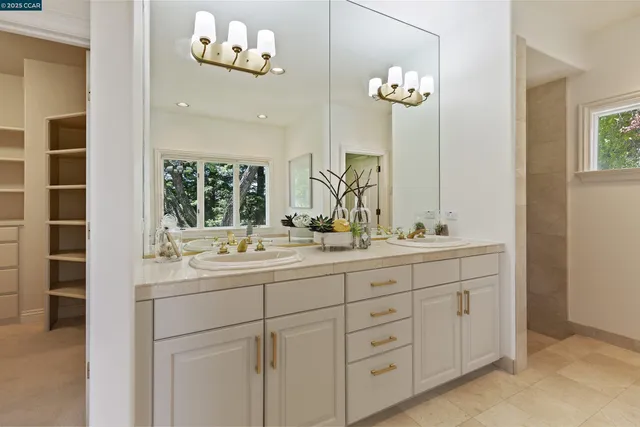 a spacious bathroom with a tub sink and mirror
