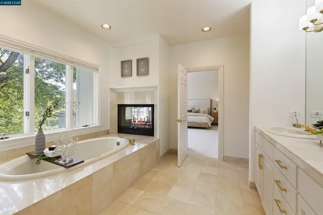 a bedroom with furniture and a large window