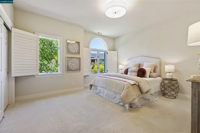 a bedroom with a large bed and a large window