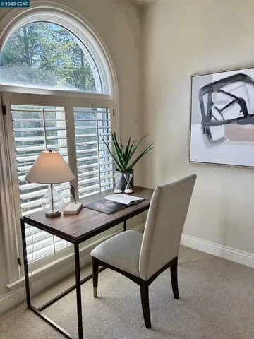a bedroom with bed and a large window