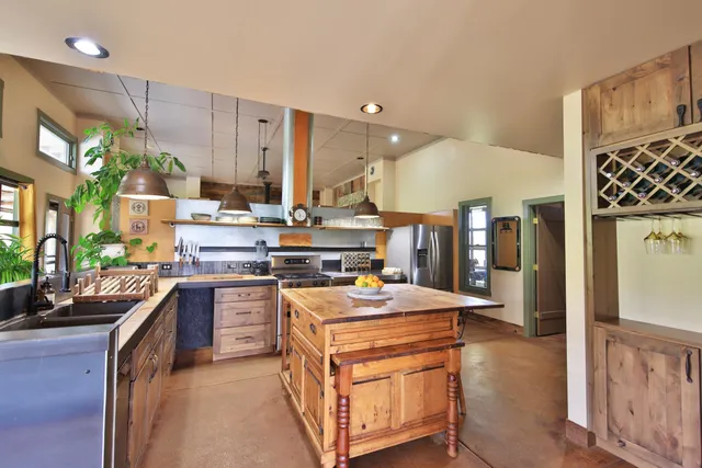 a kitchen with stainless steel appliances a table chairs and white cabinets