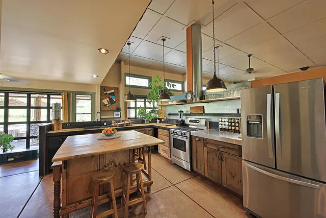 a living room with furniture a rug and a table