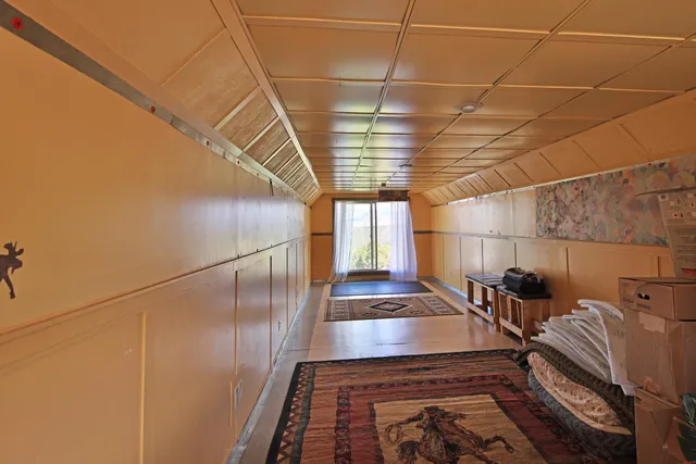 a bedroom with bed and balcony