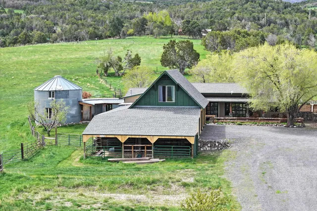 a view of a house with a yard balcony and sitting area