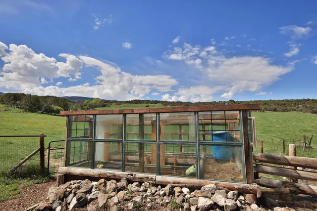 a view of a table and chairs in backyard